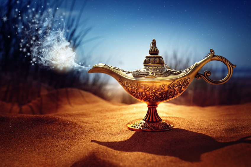 Magic lamp in the desert from the story of Aladdin with Genie appearing in blue smoke concept for wishing, luck and magic